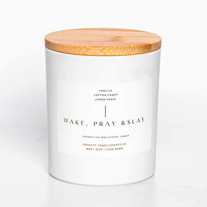 white candle jar with wooden lid, and white label reading "Wake, Pray, & Slay" 